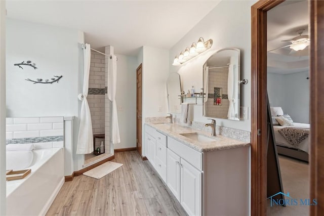 2393 Woods Edge Rd, Perrysburg, OH 43551 - full bath featuring a shower stall, a garden tub, double vanity, ceiling fan, and wood finished floors