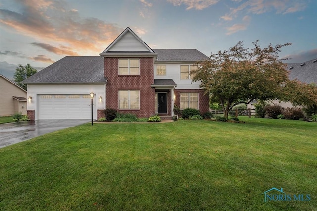2393 Woods Edge Rd, Perrysburg, OH 43551 - traditional home featuring an attached garage, brick siding, driveway, and a lawn