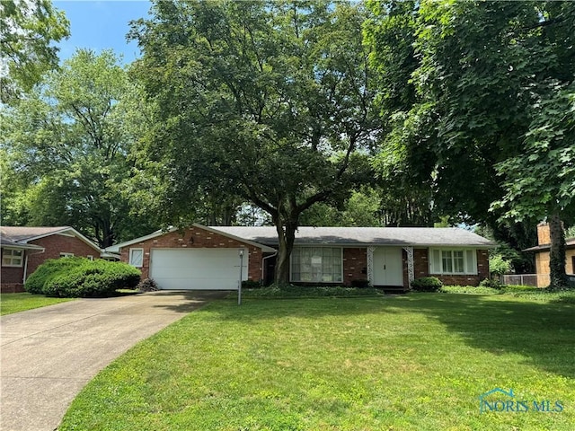 3425 Orchard Trail Dr, Toledo, OH 43606 - ranch-style home featuring driveway, a garage, brick siding, and a front lawn