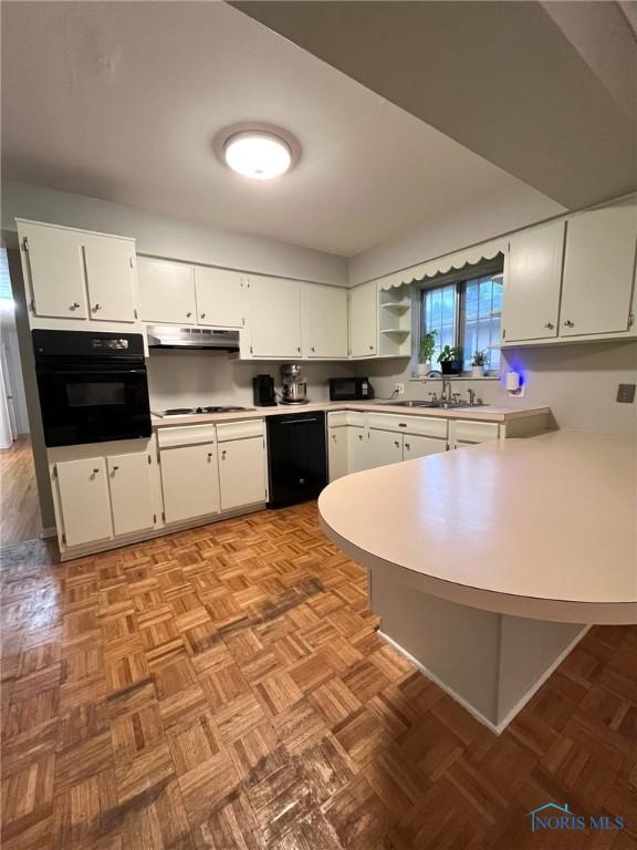 4409 Merry Ln, Toledo, OH 43615 - kitchen with black appliances, light countertops, a peninsula, and white cabinets