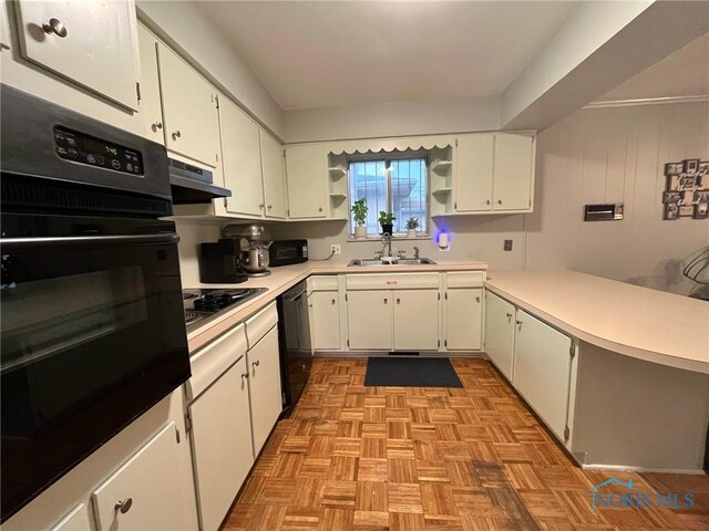 4409 Merry Ln, Toledo, OH 43615 - kitchen with black appliances, open shelves, under cabinet range hood, a peninsula, and white cabinets