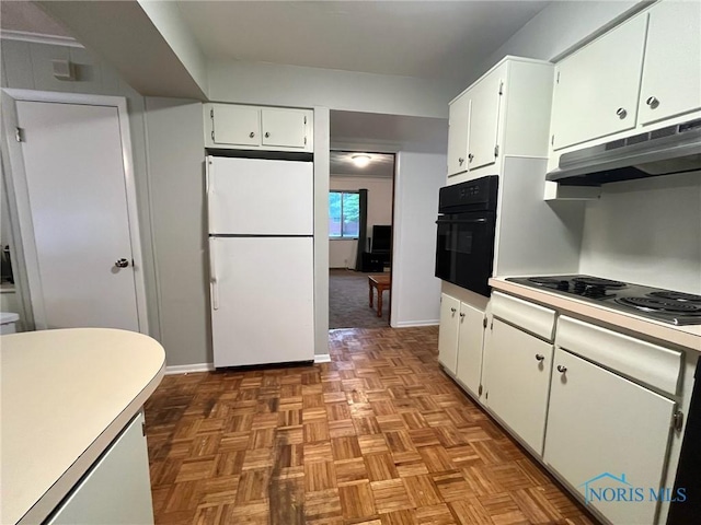 4409 Merry Ln, Toledo, OH 43615 - kitchen with freestanding refrigerator, black oven, electric stovetop, under cabinet range hood, and white cabinets
