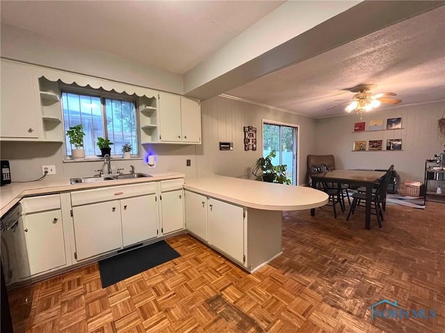 4409 Merry Ln, Toledo, OH 43615 - kitchen featuring open shelves, light countertops, a peninsula, white cabinetry, and plenty of natural light
