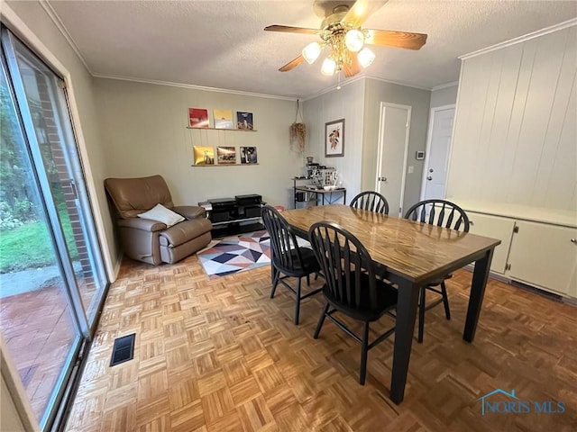 4409 Merry Ln, Toledo, OH 43615 - dining room with a textured ceiling, ceiling fan, ornamental molding, and wooden walls