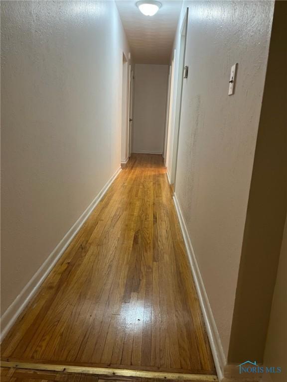 4409 Merry Ln, Toledo, OH 43615 - corridor featuring light wood-style flooring and baseboards