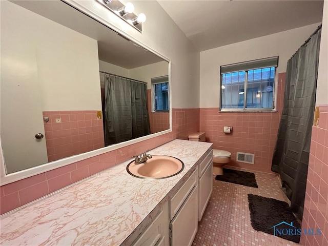 4409 Merry Ln, Toledo, OH 43615 - bathroom featuring tile walls, tile patterned flooring, vanity, a shower with shower curtain, and wainscoting