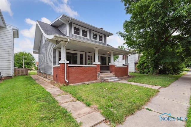 108 Western Ave, Findlay, OH 45840 - view of front of home with covered porch, a front lawn, and brick siding