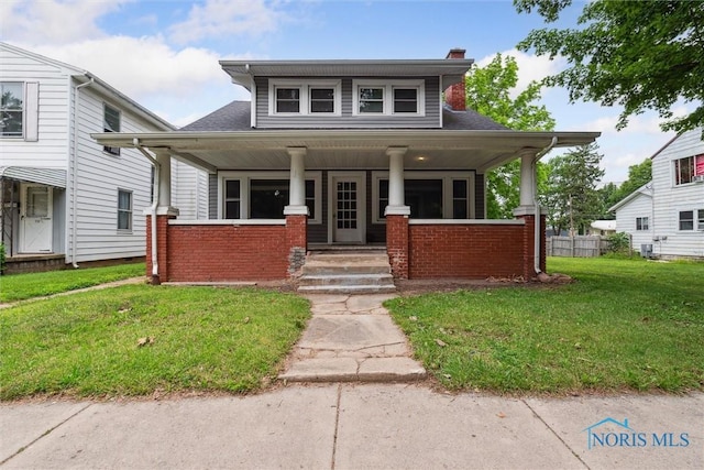 108 Western Ave, Findlay, OH 45840 - view of front of property featuring a porch, a front lawn, a chimney, and brick siding