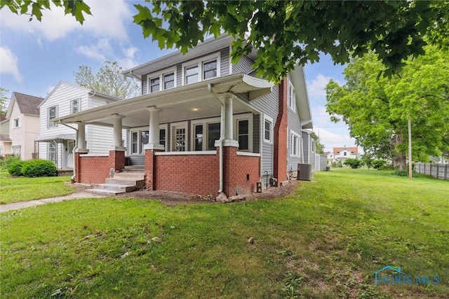 108 Western Ave, Findlay, OH 45840 - traditional style home featuring a porch, a front lawn, and brick siding