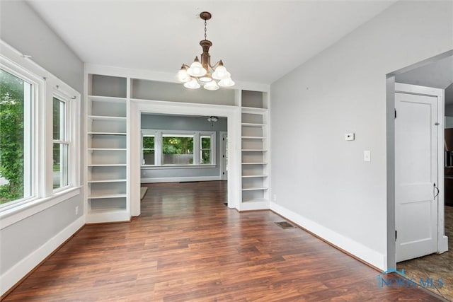108 Western Ave, Findlay, OH 45840 - unfurnished dining area featuring healthy amount of natural light, built in shelves, a chandelier, and wood finished floors
