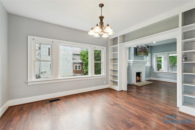 108 Western Ave, Findlay, OH 45840 - unfurnished living room with a chandelier, a fireplace, wood finished floors, and built in features
