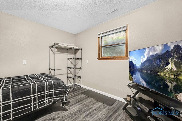 616 Normandie Blvd, Bowling Green, OH 43402 - bedroom with dark wood finished floors and a textured ceiling
