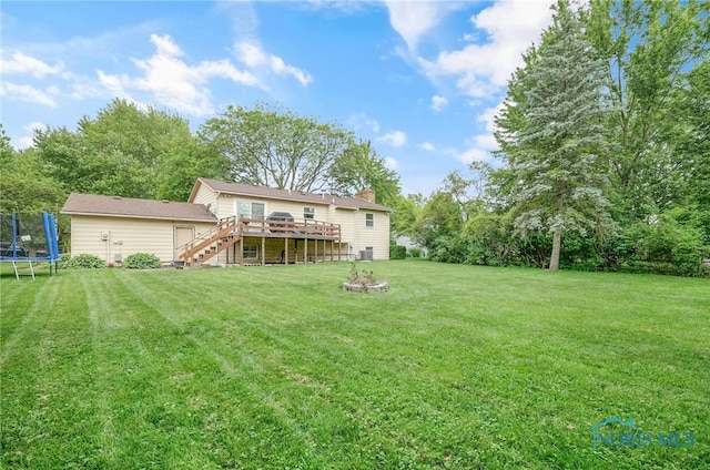 616 Normandie Blvd, Bowling Green, OH 43402 - rear view of property featuring a trampoline, stairway, a deck, a yard, and a chimney