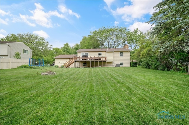 616 Normandie Blvd, Bowling Green, OH 43402 - rear view of house featuring a trampoline, stairway, a wooden deck, and a chimney