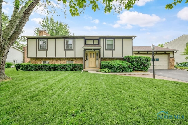616 Normandie Blvd, Bowling Green, OH 43402 - split foyer home with driveway, a chimney, an attached garage, and brick siding
