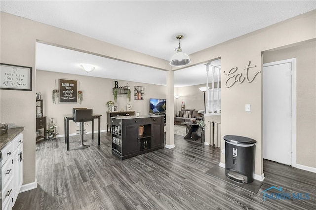 616 Normandie Blvd, Bowling Green, OH 43402 - kitchen featuring dark wood-style flooring, white cabinets, and pendant lighting