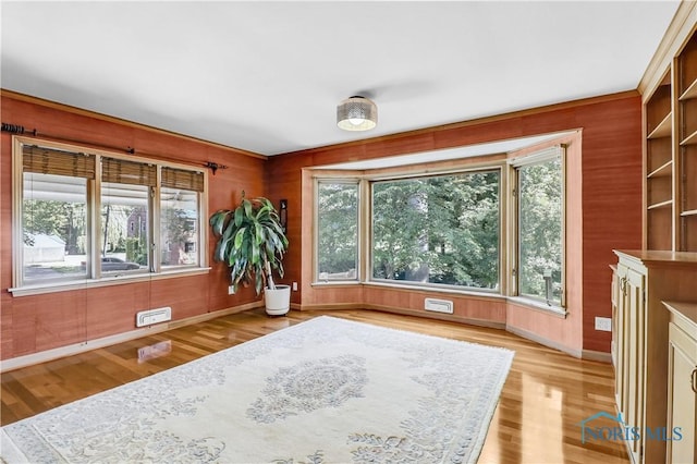 3998 W Bancroft St, Ottawa Hills, OH 43606 - living area featuring plenty of natural light, light wood finished floors, and wood walls