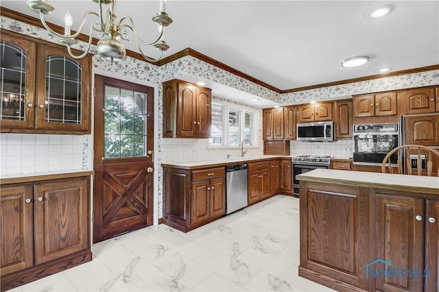3998 W Bancroft St, Ottawa Hills, OH 43606 - kitchen with stainless steel appliances, ornamental molding, plenty of natural light, a chandelier, and light countertops