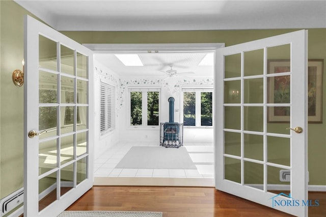 3998 W Bancroft St, Ottawa Hills, OH 43606 - unfurnished sunroom featuring french doors and a wood stove
