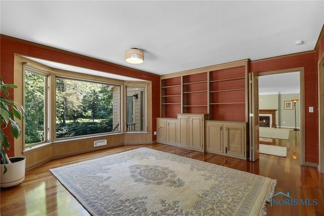 3998 W Bancroft St, Ottawa Hills, OH 43606 - interior space featuring wood finished floors and a warm lit fireplace