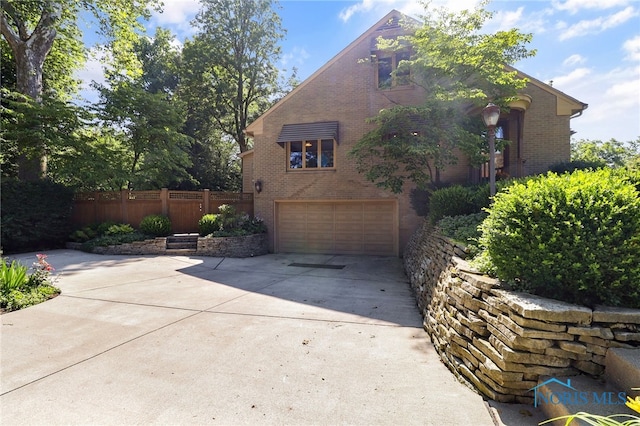 3998 W Bancroft St, Ottawa Hills, OH 43606 - view of home's exterior featuring concrete driveway, brick siding, and a garage