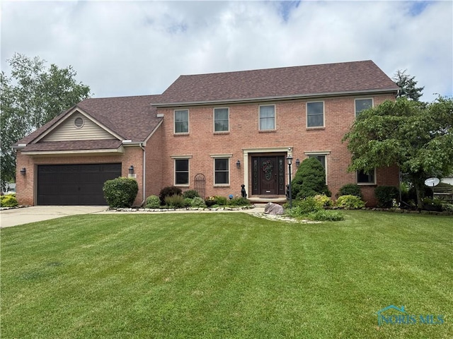 1207 Sandy Glen Dr, Perrysburg, OH 43551 - colonial house with brick siding, a front yard, driveway, an attached garage, and roof with shingles