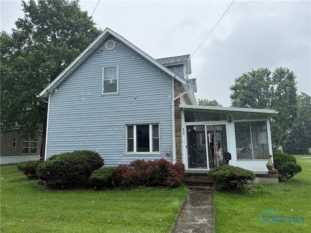 430 N Main St, Dunkirk, OH 45836 - view of front of home with a sunroom and a front yard