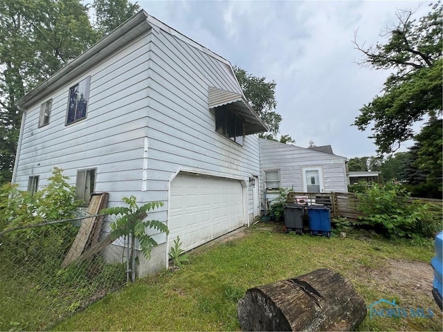 2017 Newport Ave, Toledo, OH 43613 - rear view of property with an attached garage