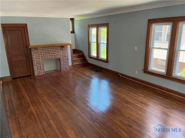 4033 Eastway St, Toledo, OH 43612 - unfurnished living room with wood finished floors, stairs, and a tile fireplace