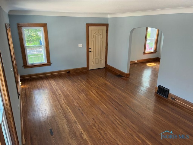 4033 Eastway St, Toledo, OH 43612 - unfurnished living room featuring arched walkways and dark wood-style flooring