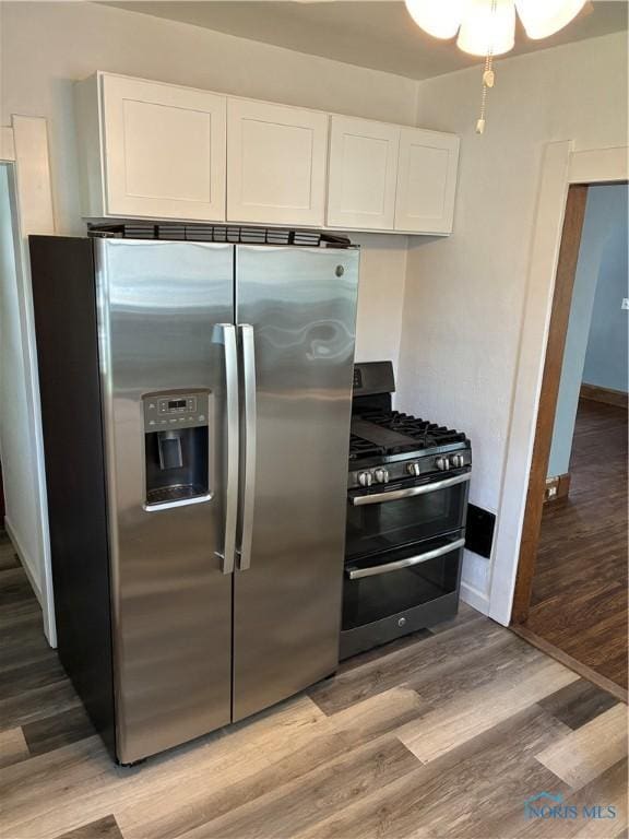 4033 Eastway St, Toledo, OH 43612 - kitchen with appliances with stainless steel finishes, light wood-style floors, and white cabinets