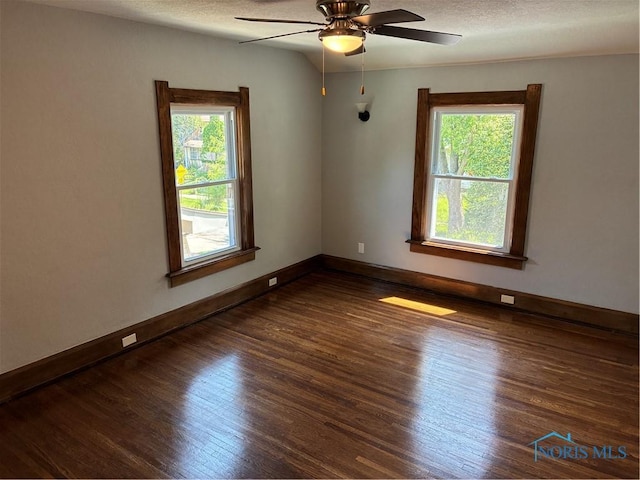 4033 Eastway St, Toledo, OH 43612 - unfurnished room with healthy amount of natural light, dark wood-style floors, and a ceiling fan