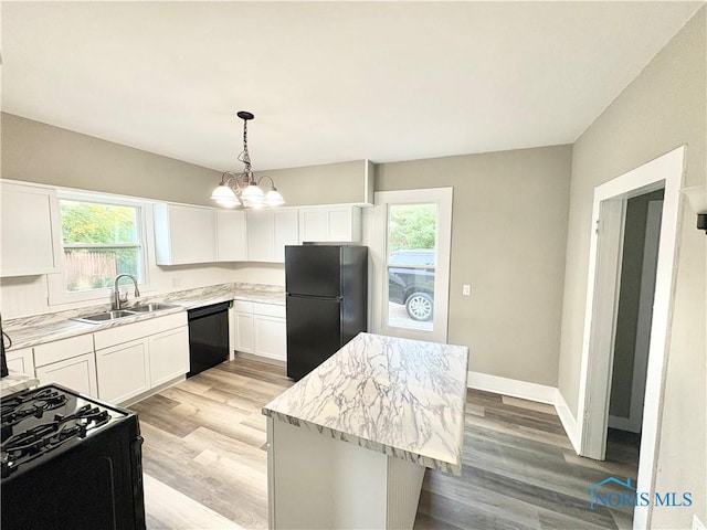 127 W Maumee Ave, Napoleon, OH 43545 - kitchen featuring black appliances, healthy amount of natural light, and light wood-style flooring