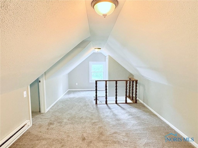 127 W Maumee Ave, Napoleon, OH 43545 - additional living space featuring a baseboard heating unit, a textured ceiling, carpet flooring, and lofted ceiling