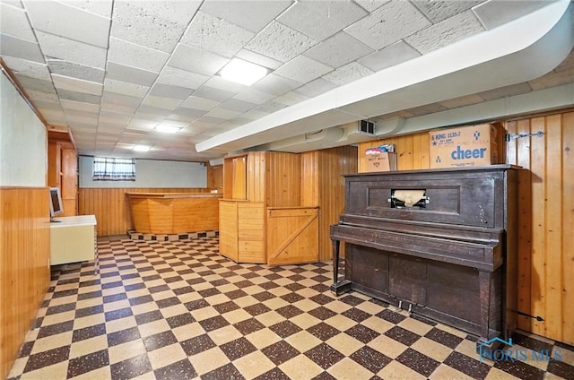 2632 117th St, Toledo, OH 43611 - basement with tile patterned floors, wooden walls, and bar area
