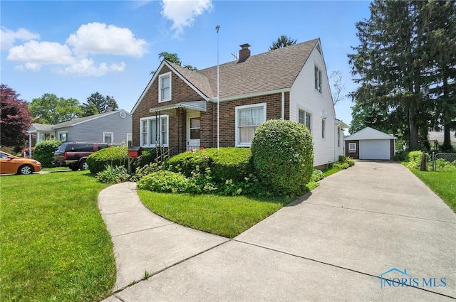 2632 117th St, Toledo, OH 43611 - bungalow-style home with a detached garage, a chimney, a front yard, an outbuilding, and brick siding