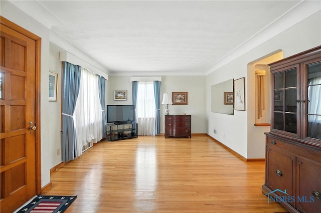 2632 117th St, Toledo, OH 43611 - unfurnished living room featuring light wood-style floors and crown molding