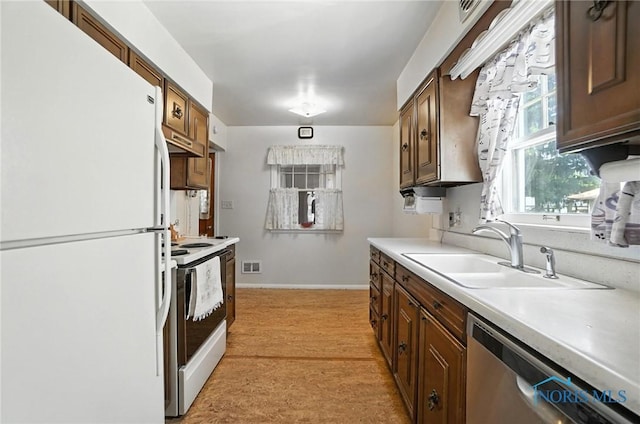 2632 117th St, Toledo, OH 43611 - kitchen with white appliances, light countertops, light carpet, and under cabinet range hood