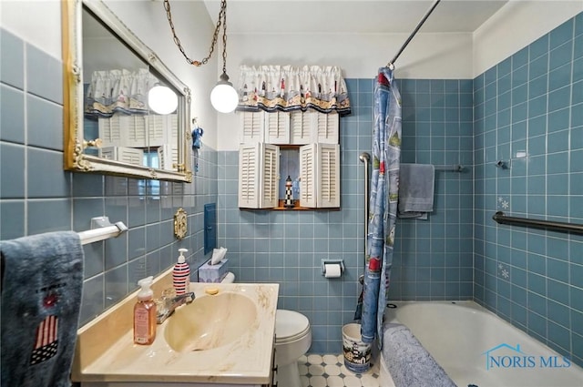 2632 117th St, Toledo, OH 43611 - bathroom with tile walls, shower / bath combination with curtain, and vanity