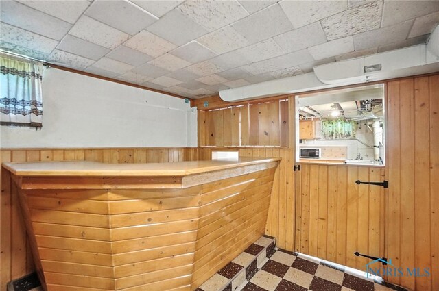 2632 117th St, Toledo, OH 43611 - bar area featuring tile patterned floors and wood walls