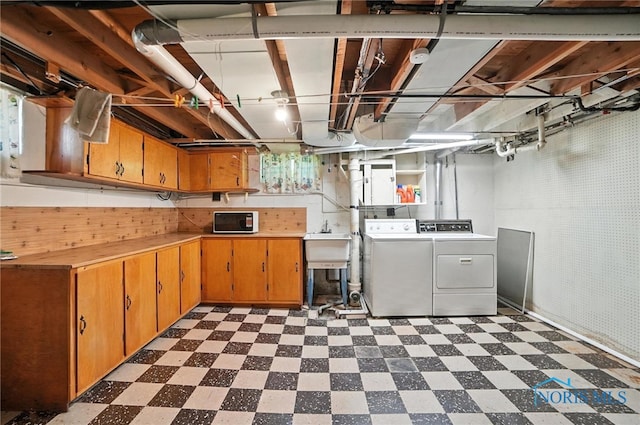 2632 117th St, Toledo, OH 43611 - below grade area featuring washer and dryer and dark flooring