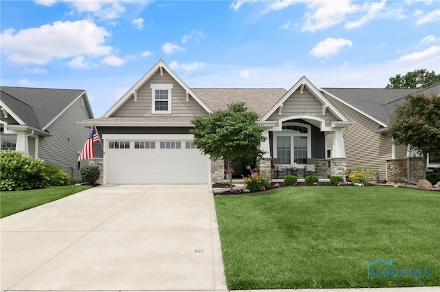 4825 Sylvan Prairie Ct, Sylvania, OH 43560 - craftsman-style house featuring stone siding, concrete driveway, a front yard, and roof with shingles