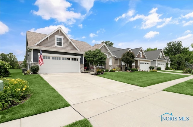 4825 Sylvan Prairie Ct, Sylvania, OH 43560 - craftsman inspired home featuring stone siding, a front lawn, and a garage