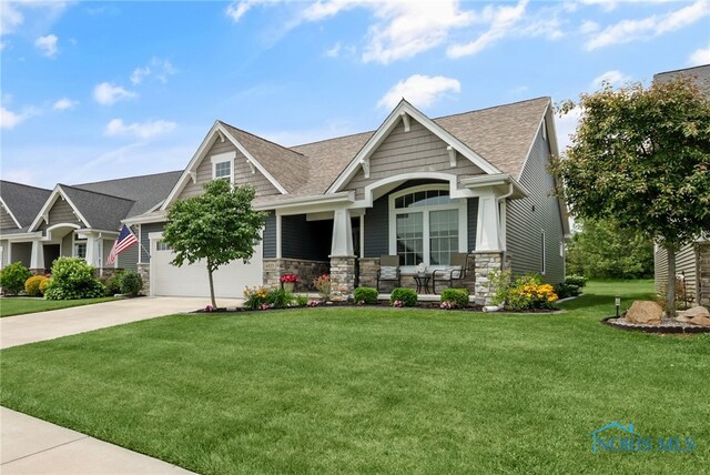 4825 Sylvan Prairie Ct, Sylvania, OH 43560 - craftsman-style home featuring a porch, concrete driveway, a front lawn, a shingled roof, and stone siding