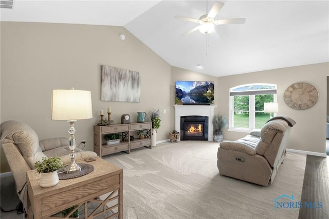 4825 Sylvan Prairie Ct, Sylvania, OH 43560 - living area with lofted ceiling, ceiling fan, a glass covered fireplace, and light colored carpet