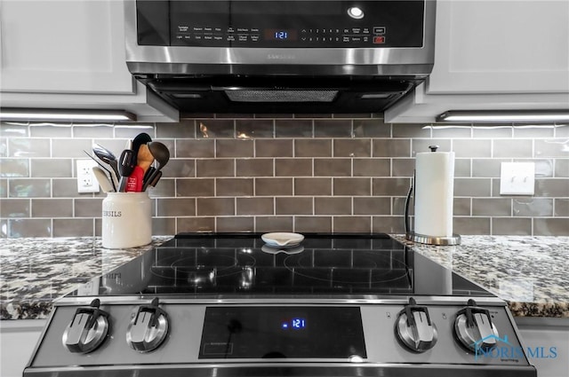 4825 Sylvan Prairie Ct, Sylvania, OH 43560 - kitchen view of tasteful backsplash, electric range, and white cabinets