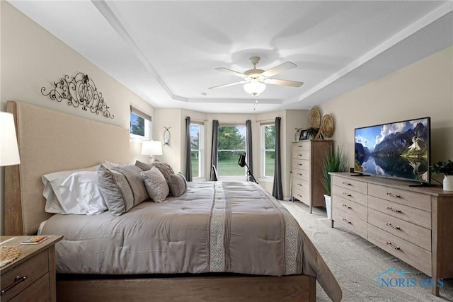 4825 Sylvan Prairie Ct, Sylvania, OH 43560 - bedroom featuring a tray ceiling, light carpet, and a ceiling fan