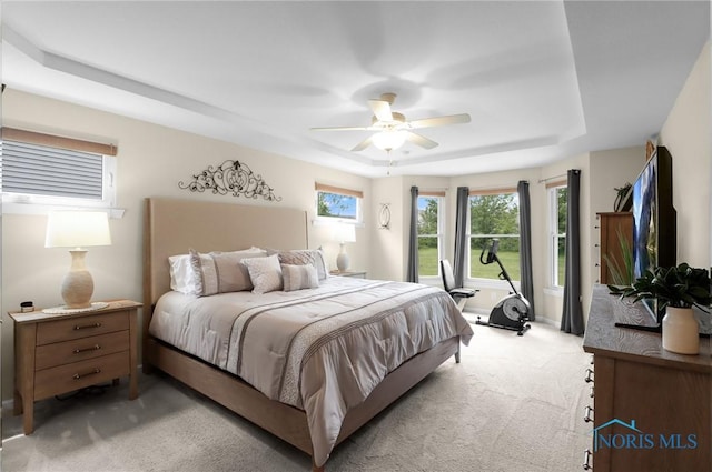 4825 Sylvan Prairie Ct, Sylvania, OH 43560 - bedroom with a raised ceiling, light colored carpet, and a ceiling fan