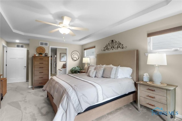 4825 Sylvan Prairie Ct, Sylvania, OH 43560 - bedroom with a raised ceiling, light carpet, ensuite bath, and a ceiling fan