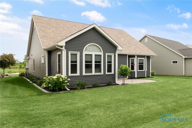 4825 Sylvan Prairie Ct, Sylvania, OH 43560 - back of house with roof with shingles, a lawn, and a patio area